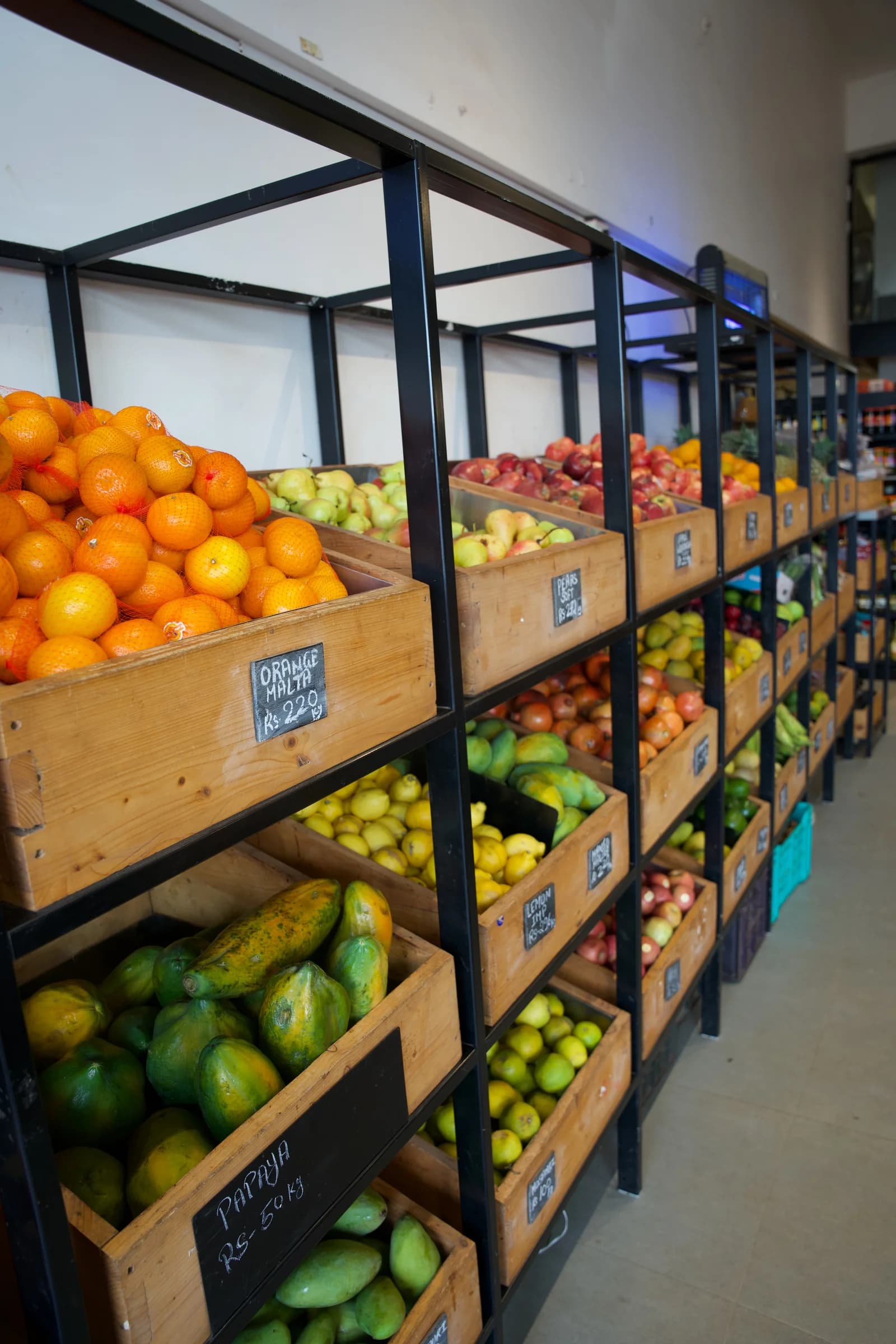 Wooden crates of fresh fruit stacked along the fruit wall